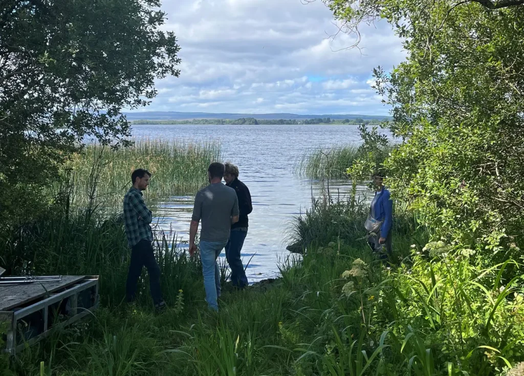 Men Standing by Lakeshore